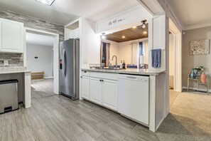 A modern kitchen with white cabinetry, a stainless steel refrigerator, and a dishwasher. - 4 Mi to UToledo! Cozy Family Home (Toledo)