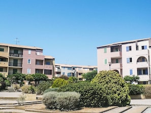 A residential building with multiple balconies, a clear sky, and well-maintained greenery. - Les Terrasses de la Méditerranée by Interhome (Saint Pierre La Mer)