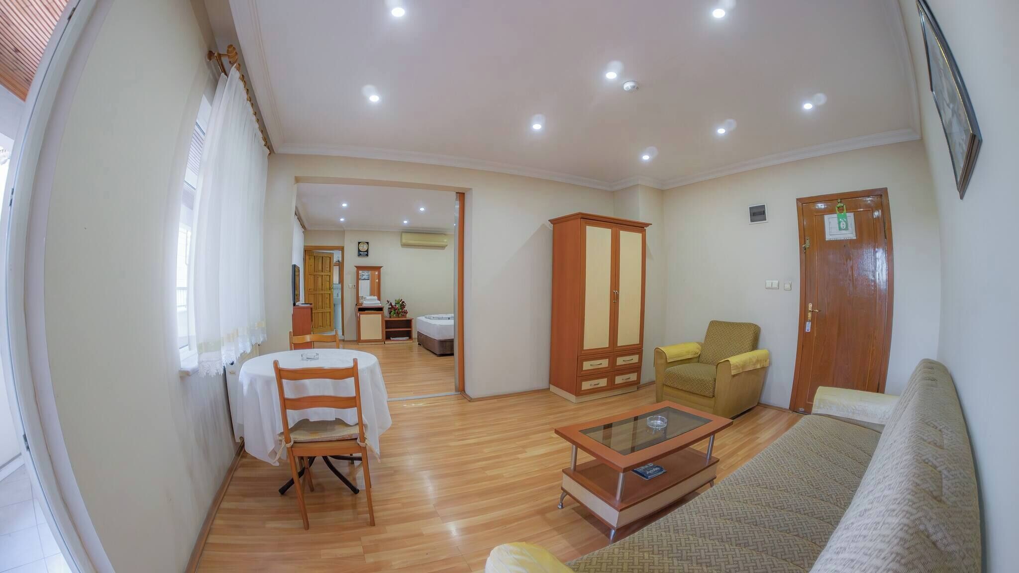 A living room with a sofa, a coffee table, a wooden cabinet, and a chair.