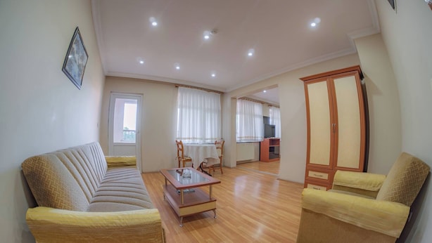 A living room with a sofa, armchairs, a coffee table, and a wardrobe. - Spacious Hopa Suite & City View (Hopa)