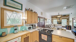 A kitchen with wooden cabinets, a stove, a microwave, and a dishwasher. - Peaceful Farm Stay Near Cuyahoga Valley NP (Cuyahoga Falls)