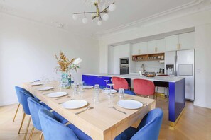A modern kitchen with white cabinets, a built-in oven, and a stainless steel refrigerator. - Luxurious apartment - 4BR/10P- Ternes/Pereire (Paris)