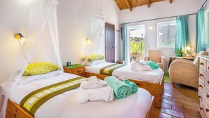 A room with two beds, each with a canopy, bedside tables, and a view of the outdoors. - Moinhos Velhos Juice Detox & Yoga (Lagos)