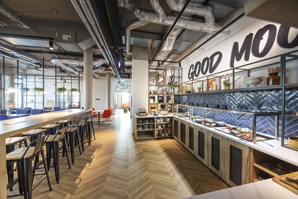 Gather for breakfast in a bright, design-forward dining hall.