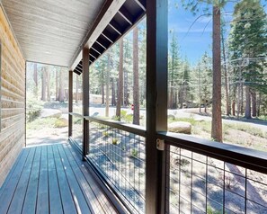 A wooden deck with a metal railing overlooking a forested area. - 10 Mins Lake/Heavenly Ski, BBQ, Deck, Modern 3BD! (South Lake Tahoe)