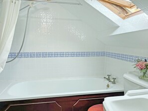 Ein Badezimmer mit einer Badewanne, einer Dusche und einem WC.