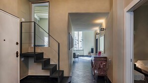 A modern interior with a staircase, a dining area, and a bed. - The Gallery House by Wonderful Italy (Genova)