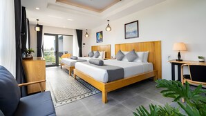A modern hotel room with a large bed, a desk, a ceiling fan, and a balcony. - Summer Beach Villa An Bang (Da Nang)