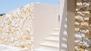 A stone wall and white steps leading to a doorway. - Villa Noema, Luxury Villa (Corfu)