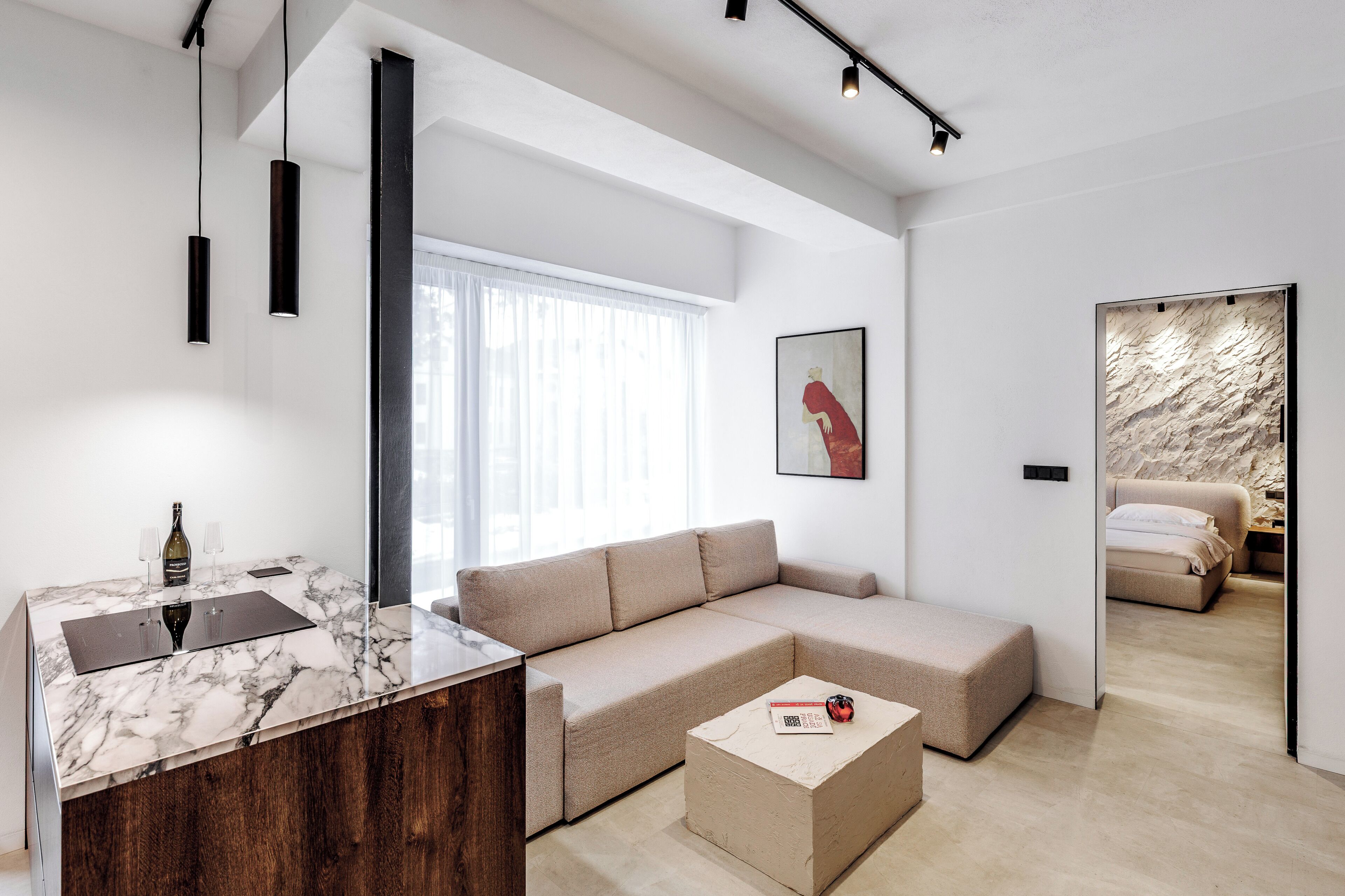 A modern living room with a marble countertop, a sofa, and a small coffee table.