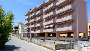 A multi-story residential building with balconies, a parking area, and a clear sky. - A bright and practical 60 square meters apartment, perfect for two people, located on the second floor of a building with an elevator (NOT accessible to people with disabilities).The property is situated in a quiet area and is ideally located for those w (Marotta)