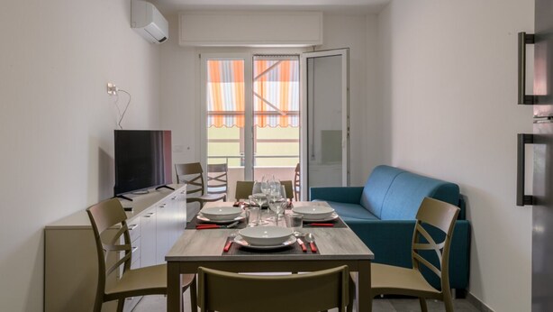 A compact living space with a dining area, a sofa, and a television. - A bright and practical 60 square meters apartment, perfect for two people, located on the second floor of a building with an elevator (NOT accessible to people with disabilities).The property is situated in a quiet area and is ideally located for those w (Marotta)