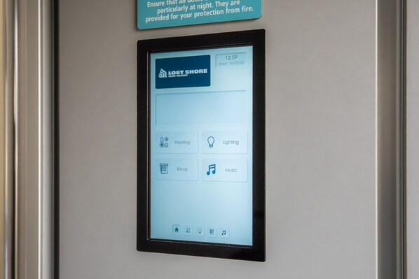 A digital control panel with options for heating, lighting, blinds, and music.