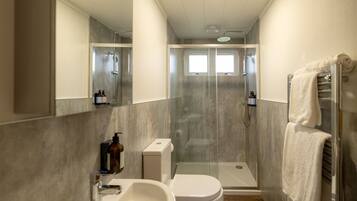 Shower, hair dryer, towels, shampoo