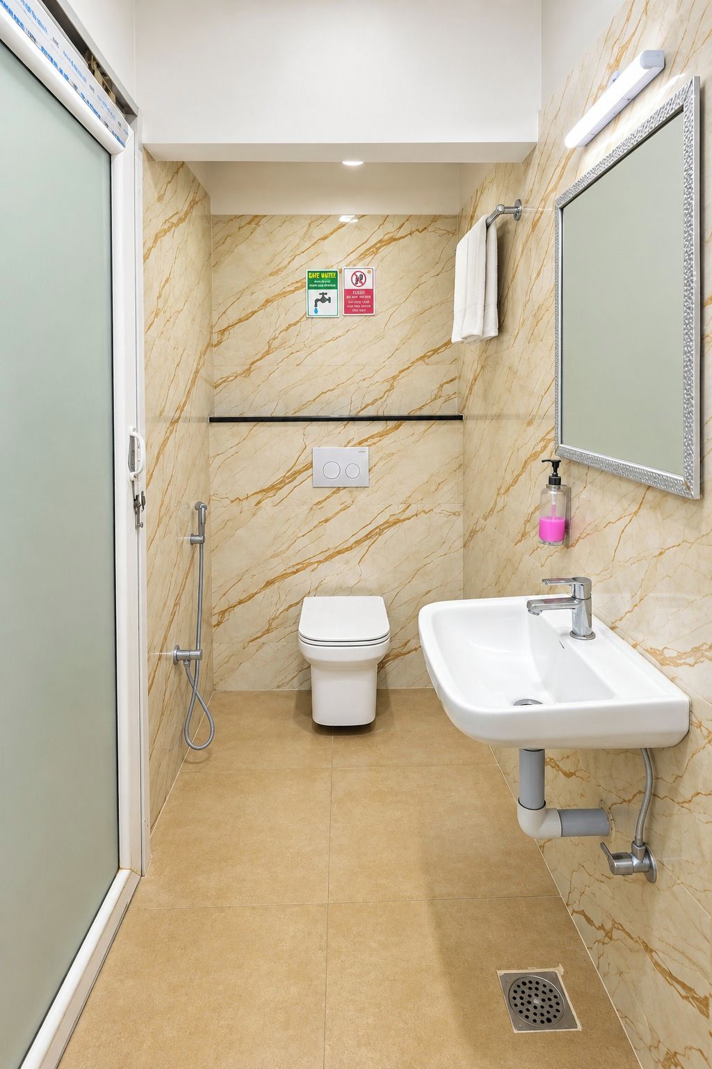 A modern bathroom with a toilet, bidet, and sink.
