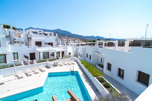 A modern hotel with a pool, white architecture, and a mountain view. - Villas de Punta Lara 18 by Casasol (Nerja)