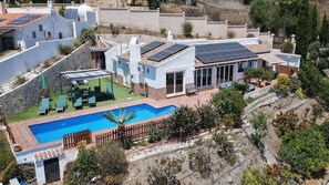 A residential property with a swimming pool, solar panels, and a patio area. - Jo's 11 - peace and relaxation with a lot of sun and sea (Arenas)