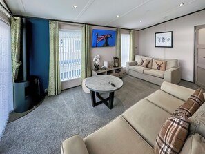 A modern living room with a sofa, a round table, and a television. - Monaco Duo - UKC9617 (Towyn)