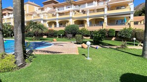 A hotel with multiple balconies, a swimming pool, and well-maintained lawns. - Senorio de Capistrano by Casasol (Nerja)