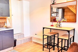 A compact kitchen with a sink, cabinets, and a countertop. - Apartment with a Mezzanine Bedroom Bordeaux (Bordeaux)