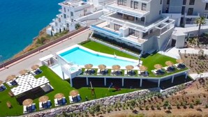 A modern hotel with a rooftop pool, multiple balconies, and a view of the sea. - Bayview Hills Deluxe by Casasol (Torrox)
