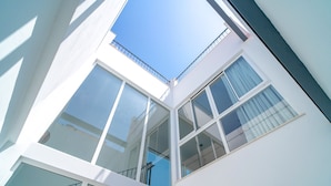 A modern building with multiple floors, large windows, and a clear sky. - Casa Solera by Casasol (Nerja)