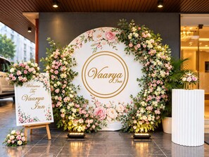 A reception area with a floral arrangement and a welcome sign for Vaarya Inn.