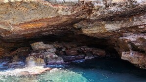 A natural cave formation with clear water and rocky walls. - Bright apartment with a spacious terrace near the ocean. (Mazarrón)