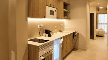 A modern kitchen with wooden cabinets, a built-in microwave, and a dishwasher.