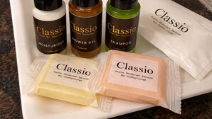 A tray with Classic Hotel toiletries including a moisturizer, shower gel, and shampoo. - Hotel Classio (Balichauki)