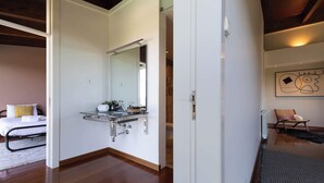 A modern bathroom with a glass shower enclosure, a white sink, and a mirror. - Sunrise Escape with Pool by Portugal Active (Viana do Castelo)