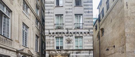 A historic building with a central entrance, multiple windows, and decorative elements.