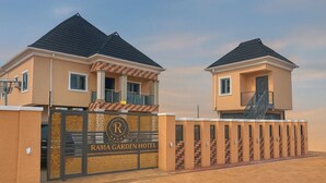 A hotel with a gated entrance, two-story buildings, and a prominent logo. - Rama Garden Hotel (Akure)