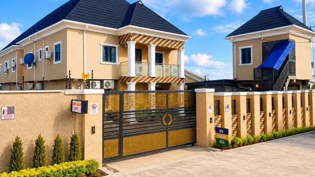 A hotel with a gated entrance, a balcony, and a staircase. - Rama Garden Hotel (Akure)