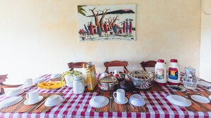 A dining table with a checkered tablecloth, various dishes, and utensils. - Relaxing 4-bedroom beach house at Malindi sand dunes perfect for family getaway (Mambrui)