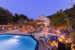 A house with a swimming pool, outdoor seating, and a well-lit patio area. - Charming 4-Bedroom Stone Villa with Pool & Garden, 15 Min to Dubrovnik (Knežica)