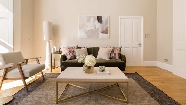 A living room with a sofa, coffee table, and a lamp. - The Steele Blue House (London)