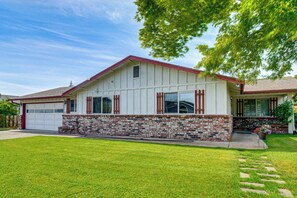 A single-story house with a garage, brick foundation, and a red roof. - 2-unit Family Combo, Walk to Downtown Sequim! (Sequim)