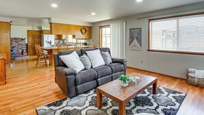 A living room with a sofa, a coffee table, and a rug.