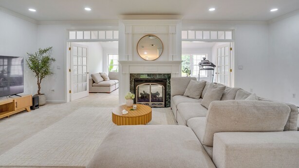 A living room with a fireplace, sofa, TV, and a plant. - Serene & Sleek Family Retreat w/ Office in Shirley (Shirley)