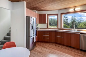 A modern kitchen with wooden cabinets, a stainless steel refrigerator, and a dishwasher. - Mistral TOT # 4838: 3  BR, 2.5  BA House in The Sea Ranch, Sleeps 6 (The Sea Ranch)