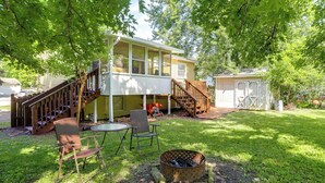 A two-story house with a covered porch, a fire pit, and outdoor seating. - Explore Oberlin! Home 1 Mi to Main Street & Campus (Oberlin)