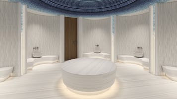 Un baño moderno con una bañera redonda central, dos lavamanos y una puerta de madera.
