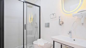 Een douche, een haardroger, pantoffels, handdoeken
