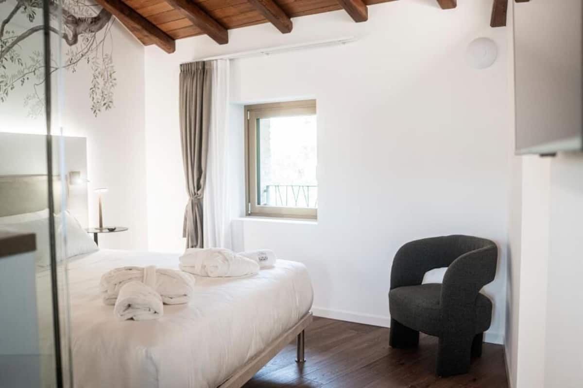 Deluxe Suite, Balcony, Mountain View | Minibar (free items), in-room safe, desk, laptop workspace