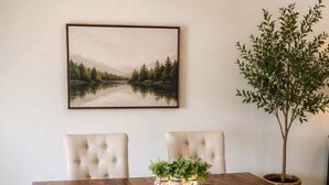 A dining table with a bench, two chairs, a potted plant, and a framed picture on the wall. - View Prime Location Min To Pkwy, Dollywood, More 3 Bedroom Condo (Sevierville)