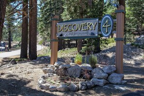 A wooden sign with the text 'Discovery Condominiums' and a number '4' on it. - Discovery 4 #132 2 Bedroom Condo (Mammoth Lakes)