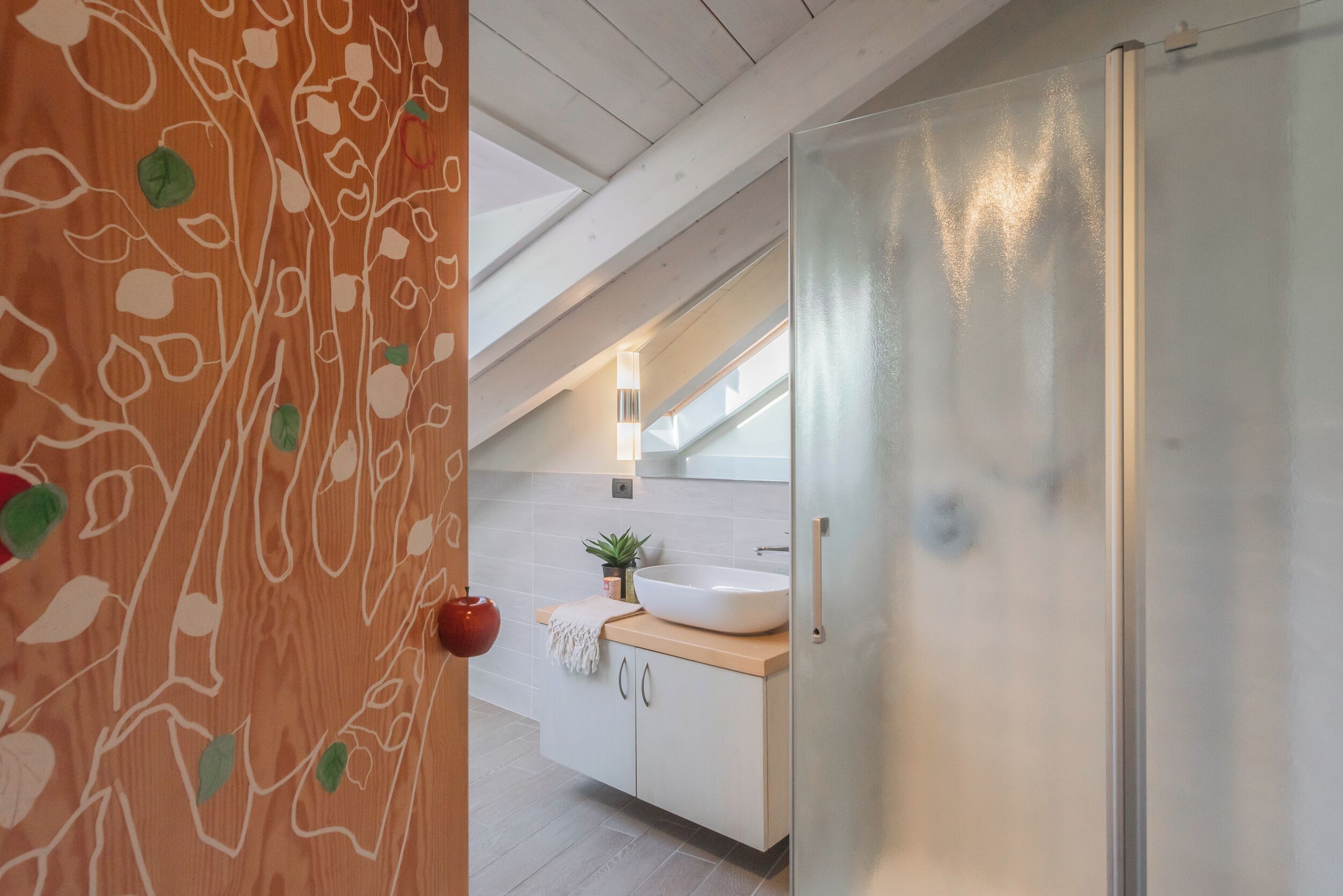 Een moderne keuken met een wit aanrecht, een ruim wastafel en een roestvrijstalen koelkast.