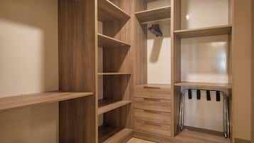 A walk-in closet with multiple wooden shelves and drawers.