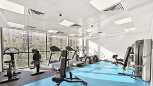 A modern gym with treadmills, elliptical machines, and weight equipment. - Bloomfields Studio in Hayat Boulevard  (Dubai)